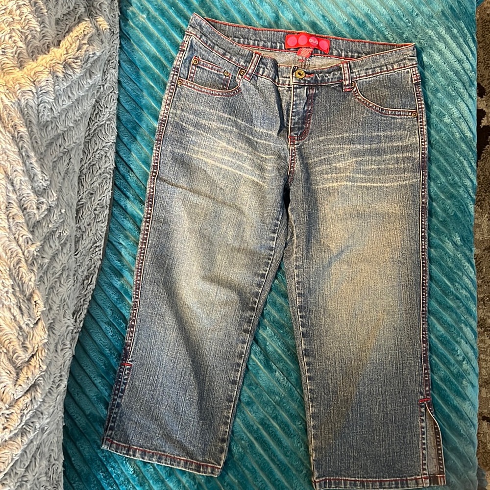 Glo Jean capri pants with red stitching.